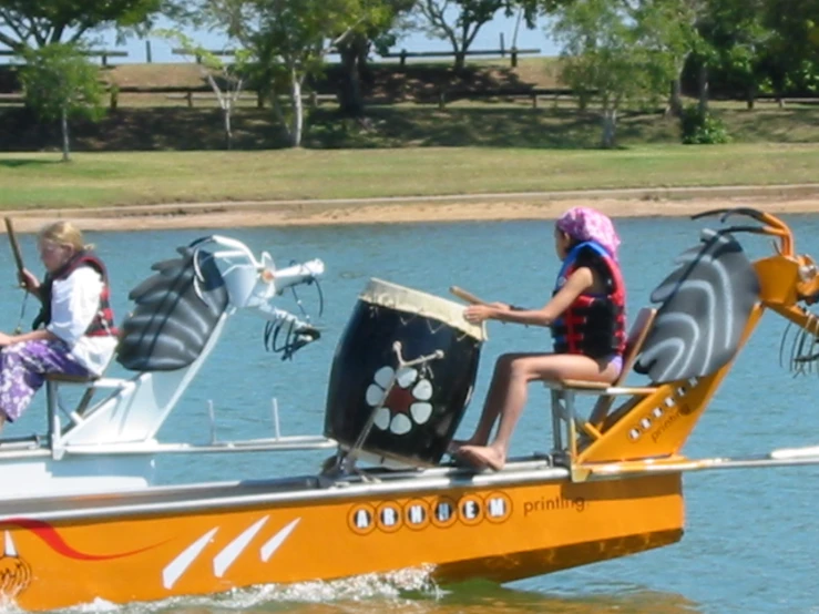 two women ride a yellow boat with three unique seats