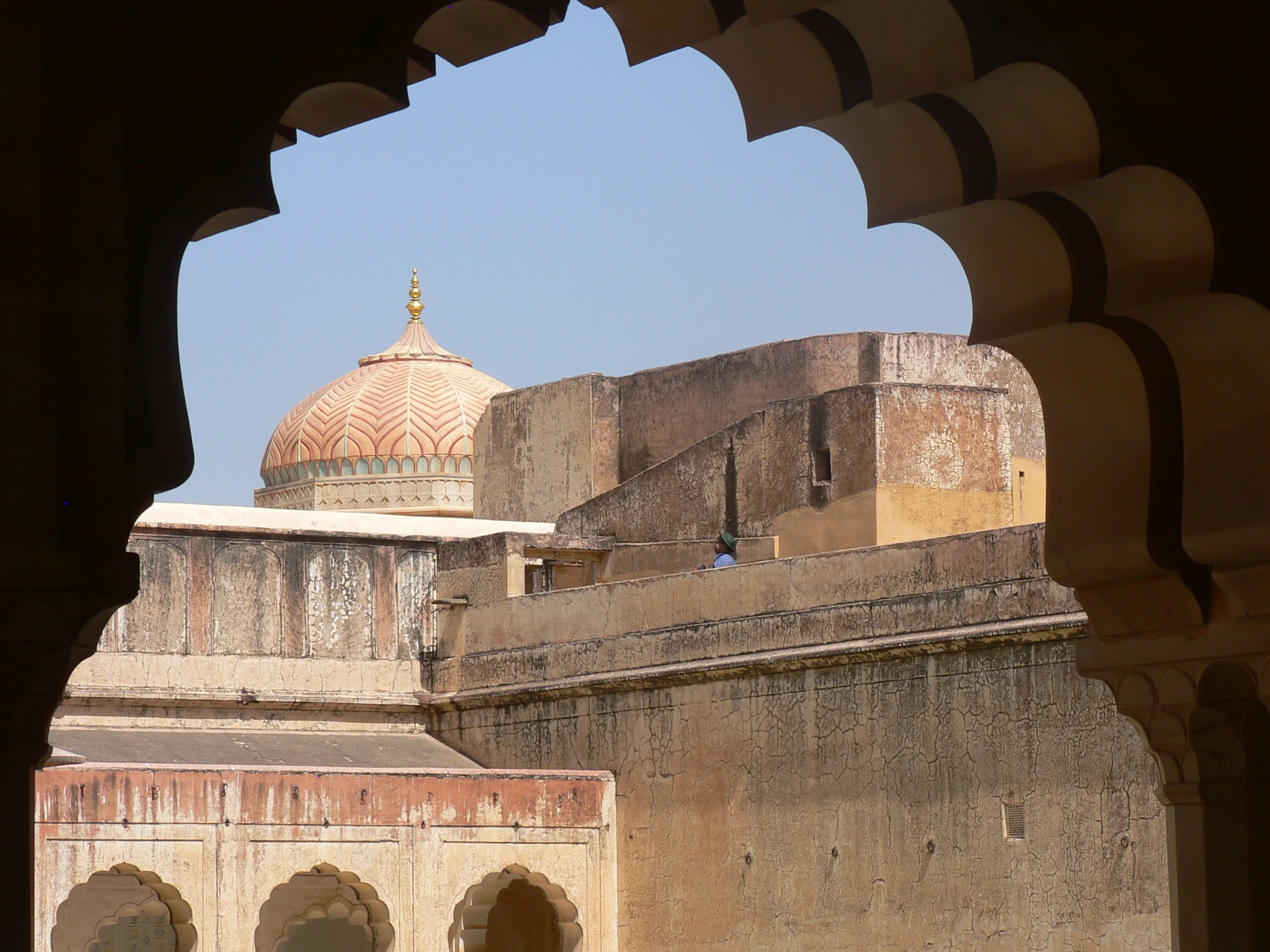 the view from under an arched doorway at an outside building