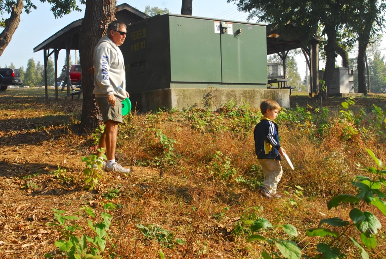 a man and a child stand in a field