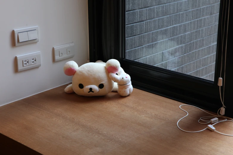 a stuffed animal in front of a window