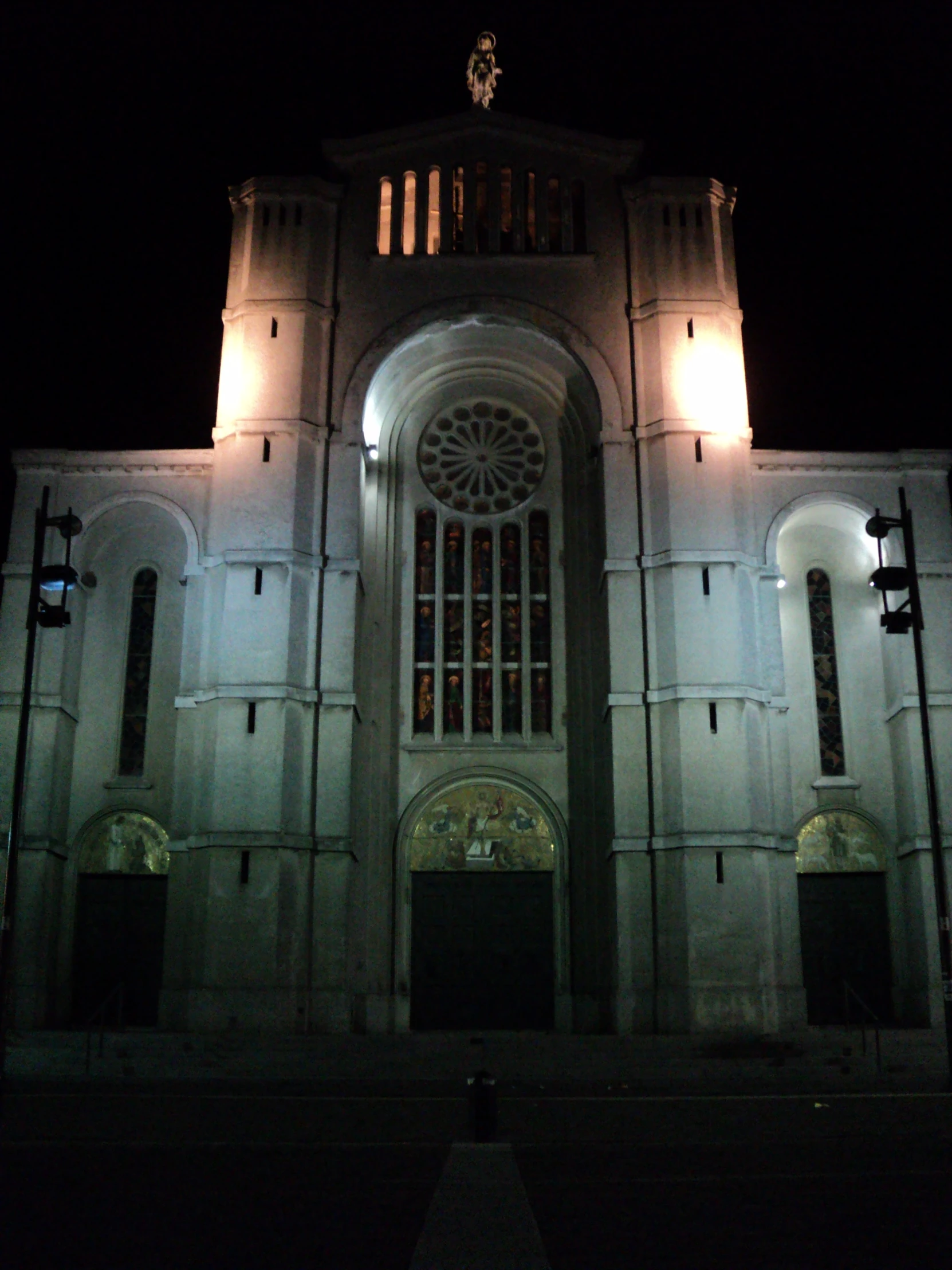 light shines on a large cathedral at night