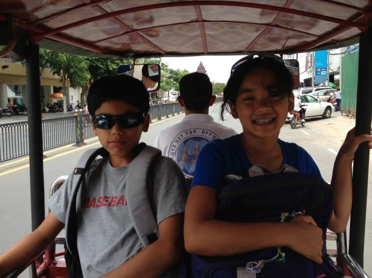 two people in a city bus and a woman with a child