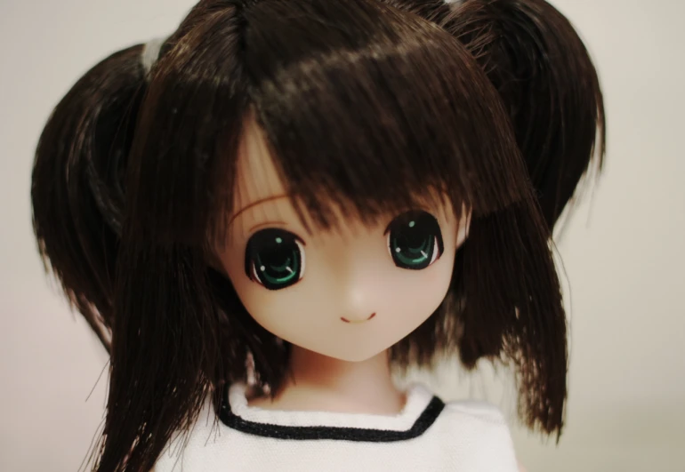 a little doll wearing green eyes and white top