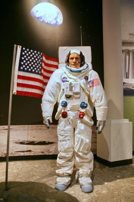 an astronaut in an astronaut suit and american flag