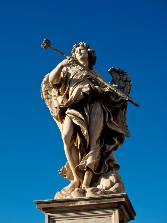 the statue shows an angel carrying a rod