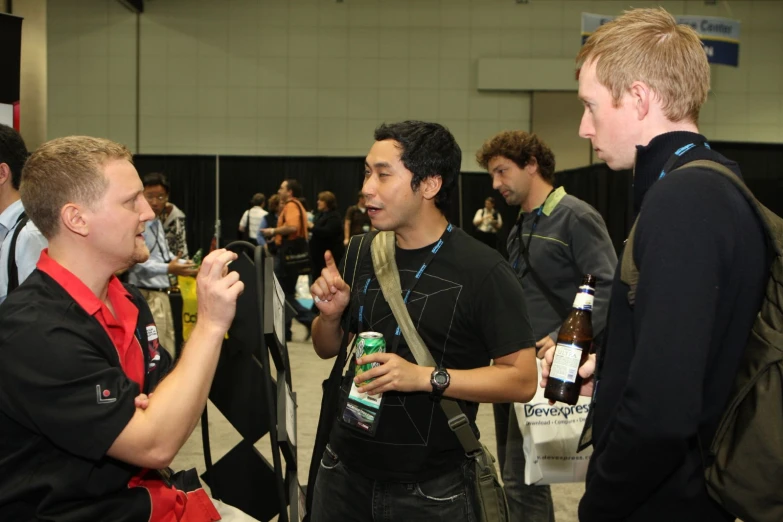 two guys at an event discussing soing while standing