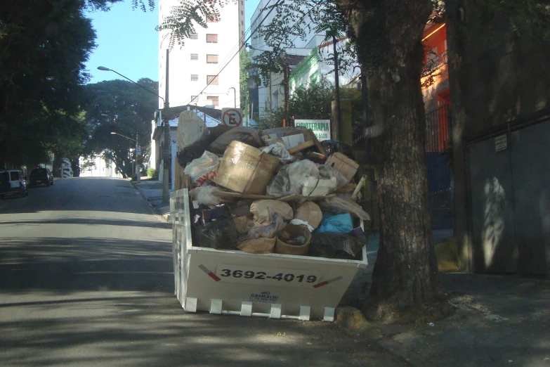 a truck full of items along side a road