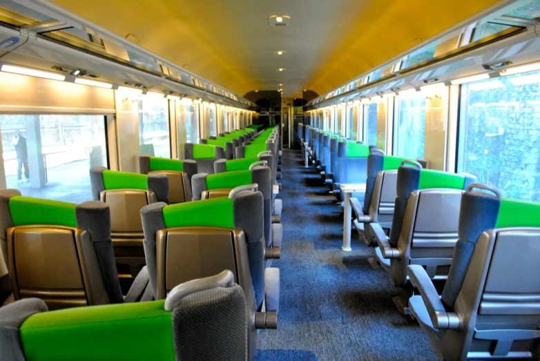 several empty seats are lined up in the front of a commuter train