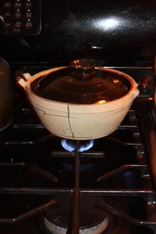 an empty pot sitting on the bottom of a stove