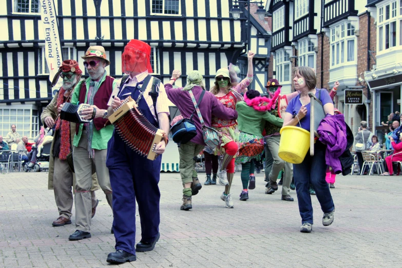 group of people dressed up in costumes and carrying objects