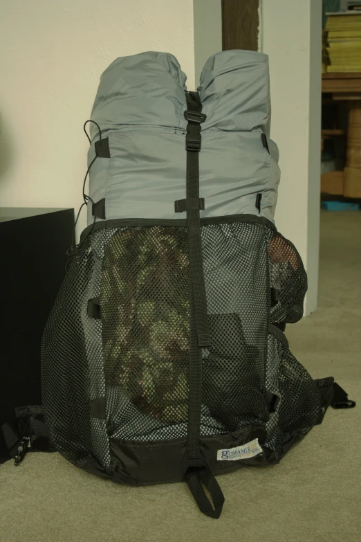 a bag with soing wrapped around it sits next to a television