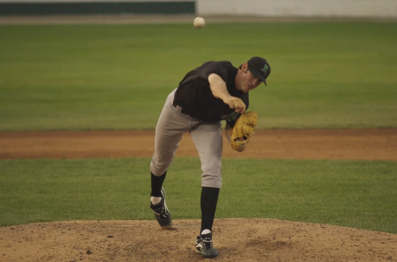 the pitcher on the mound is winding up to throw a pitch