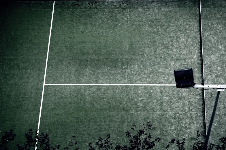 a black and white po of a tennis court with an electrical box on the side