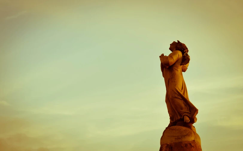 a statue with his hands in his face near the top