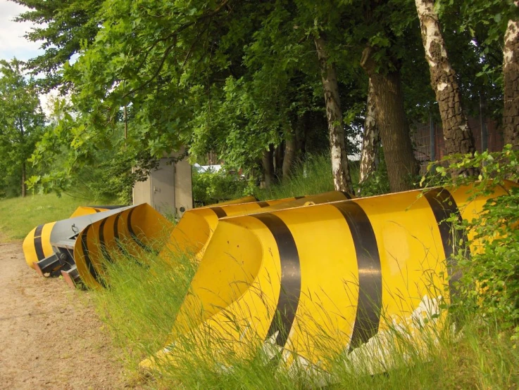 there are many yellow snow plow on this path