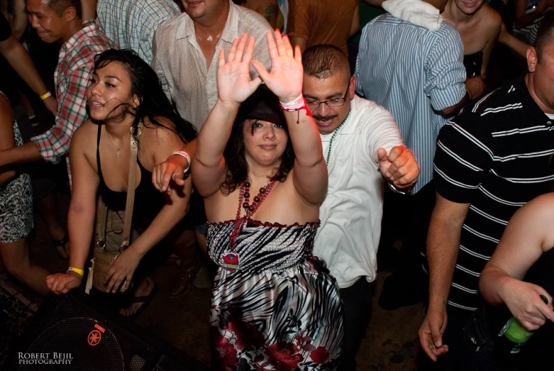 a group of people standing around each other at a party