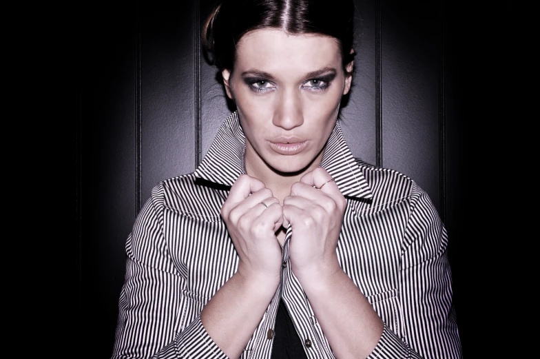 a woman in striped shirt posing for camera