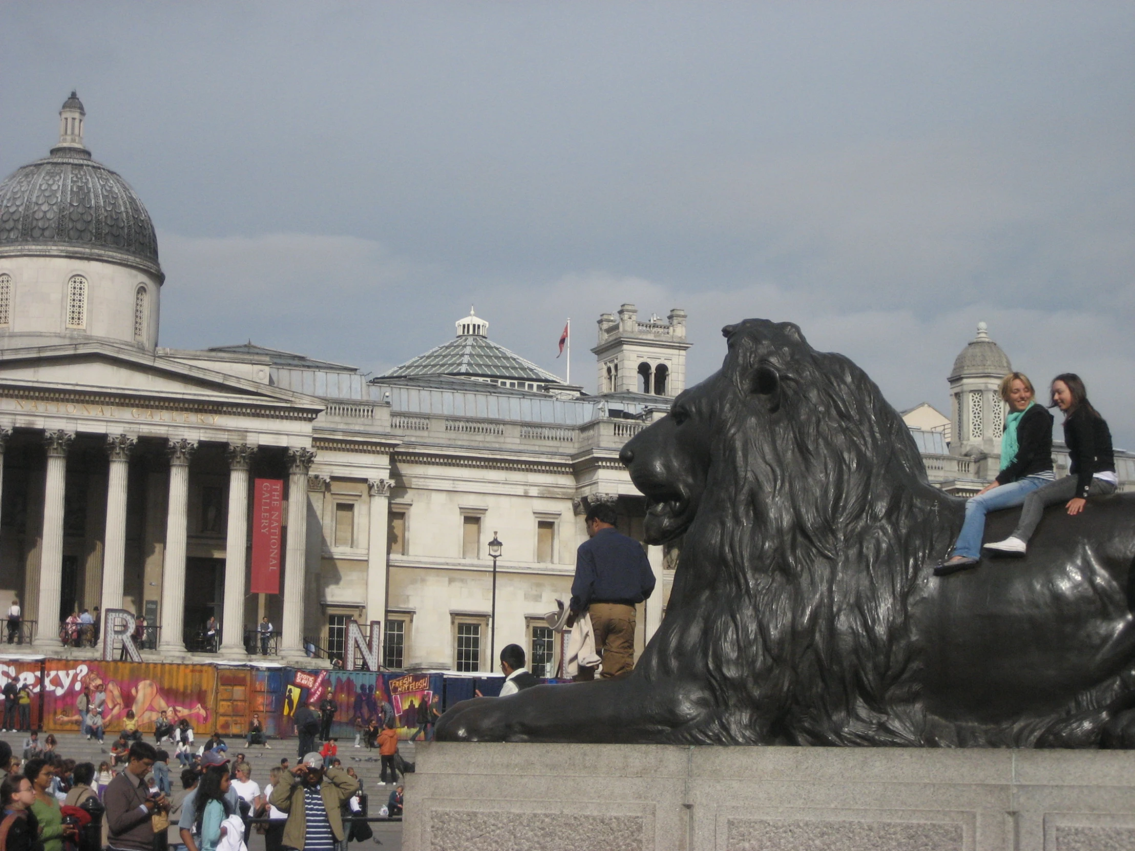 a group of people riding a statue of a dog