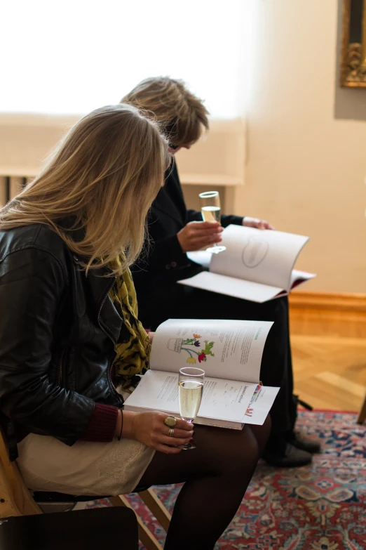 three women sitting in chairs with their drinks