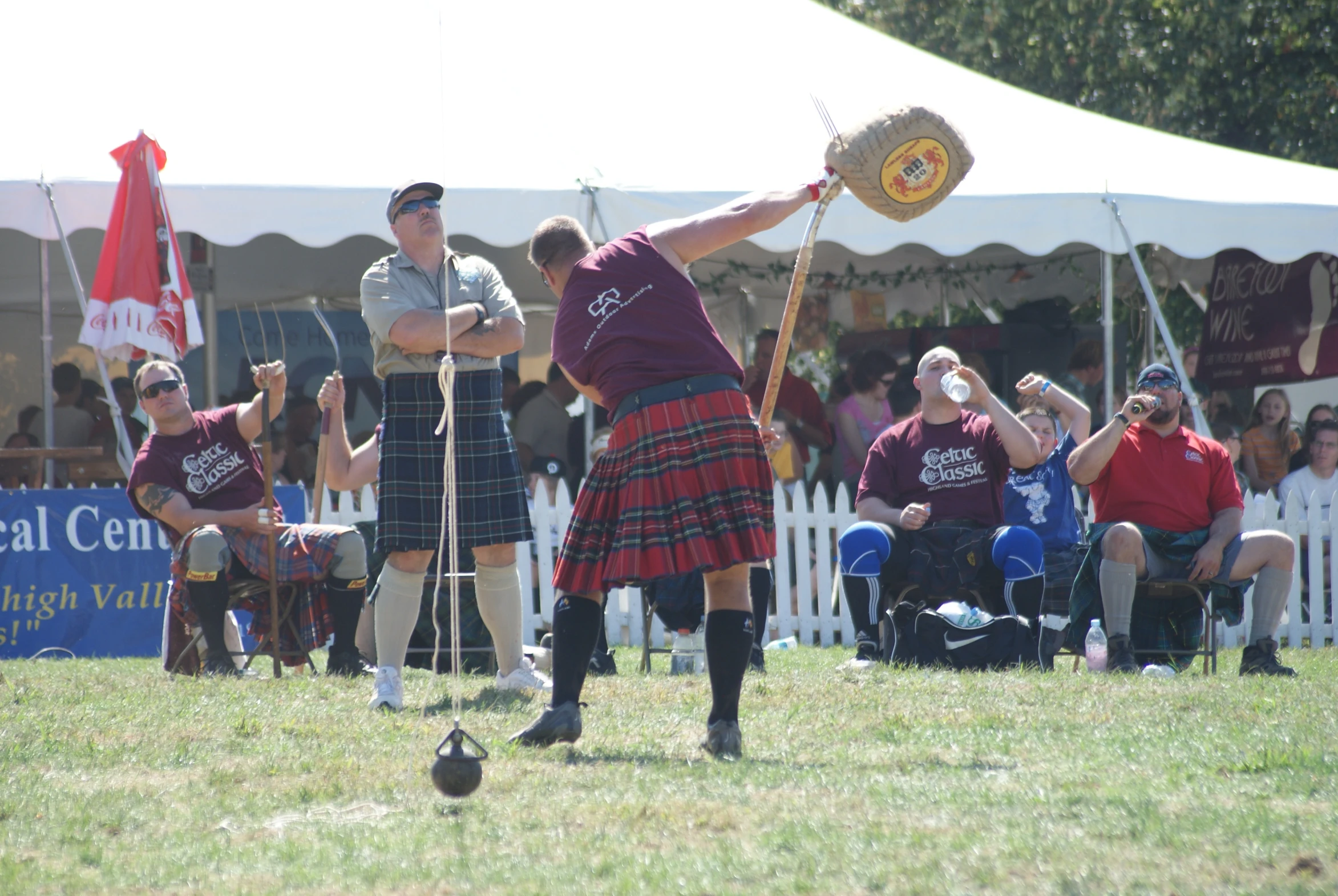 the people dressed in kilts are playing a game