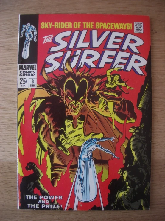 an older silver surfer comic is displayed on the table