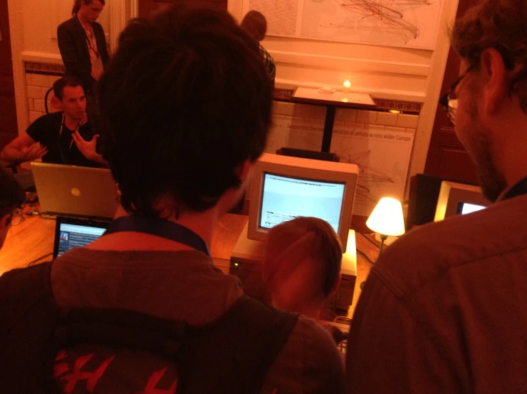 a group of people in a room with computers