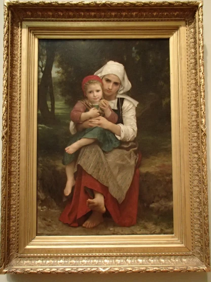 a painting in a gold frame hanging on a wall