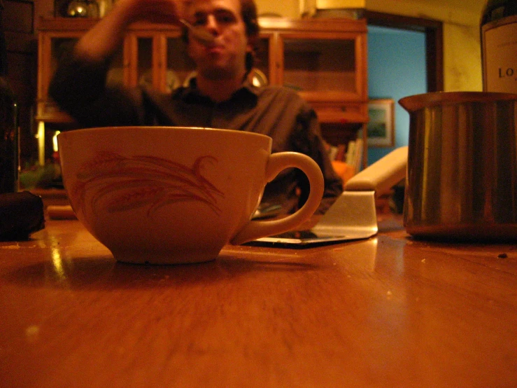 someone takes a picture of the coffee cup on their table