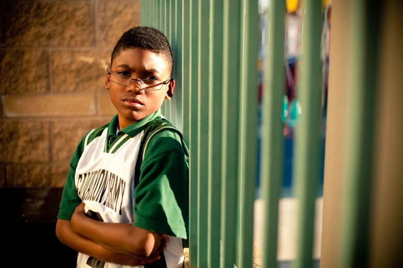 an  boy in green and white jersey posing for a po