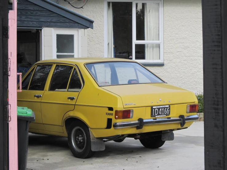 a car parked next to a house in front of a door