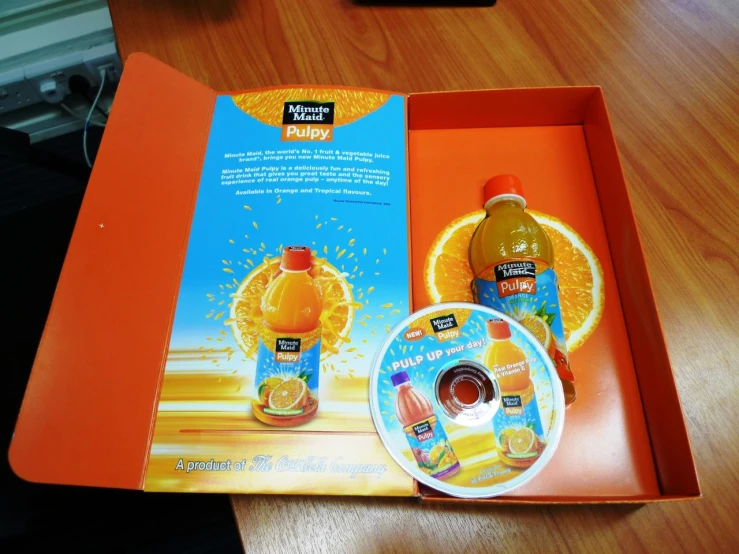 an open box of juice and another product on a table