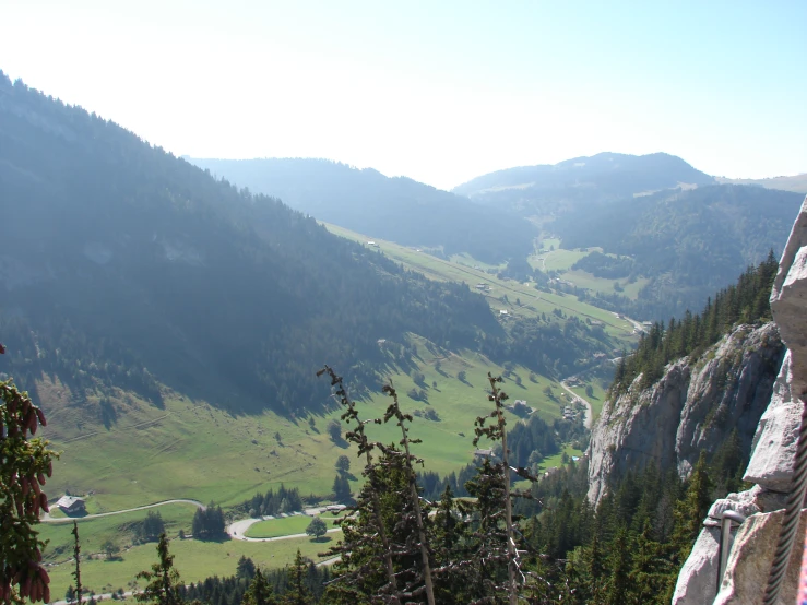 a view from the top of a mountain with rolling hills