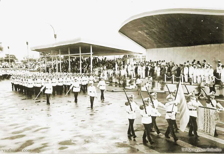 a parade with men carrying flags and a flag on one