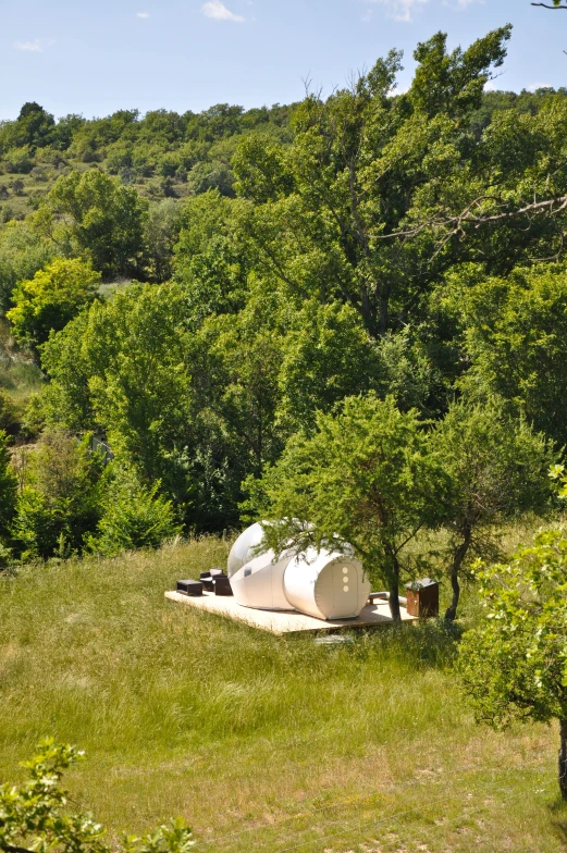 there is a toilet sitting in the middle of the field