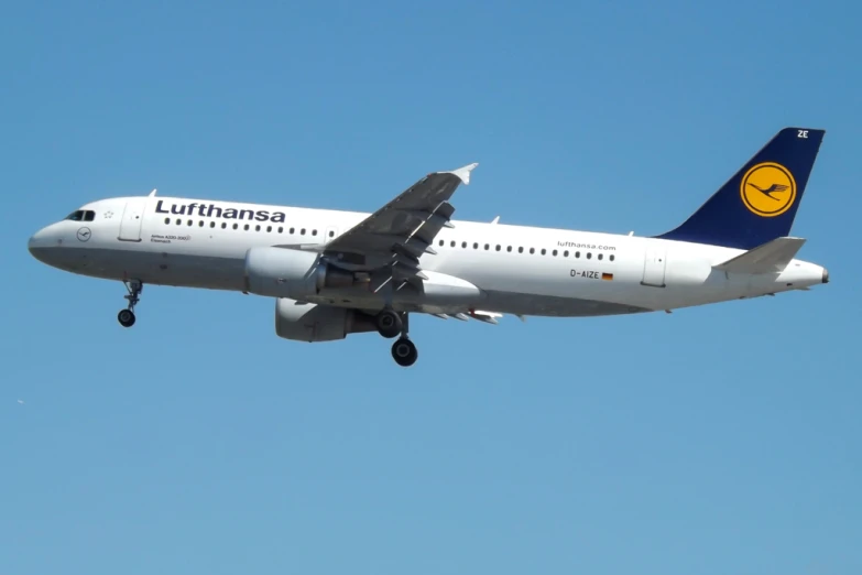 a lufthansa plane flying in a clear blue sky