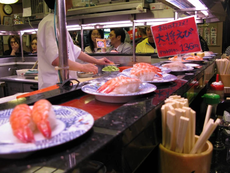 people preparing food in the kitchen at a restaurant