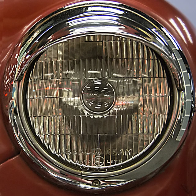 closeup of a shiny red front end view of a classic car