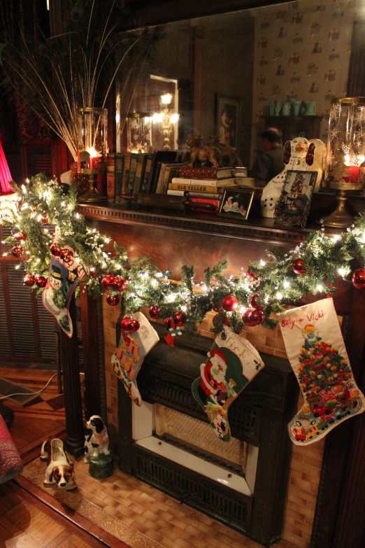 a christmas fireplace mantle with christmas stockings, christmas stockings and decorations
