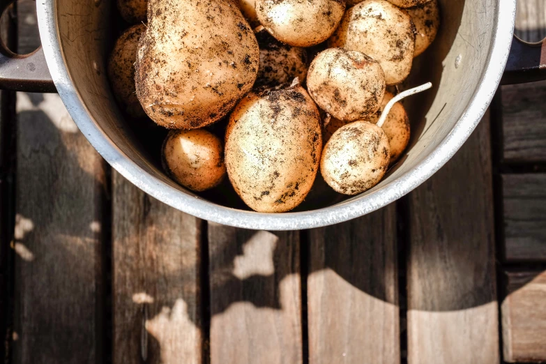 an elevated view of potatoes in a pot on the table