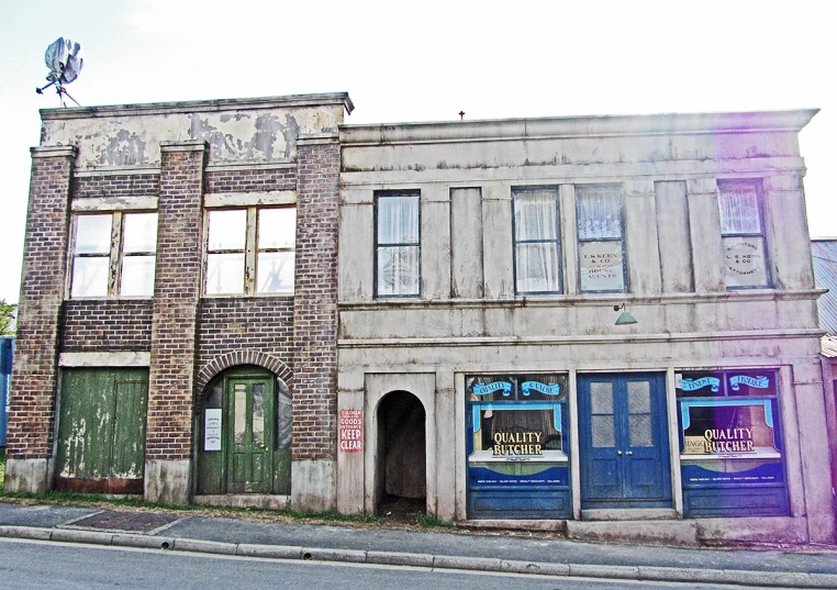 an old brick building has boarded down windows and wooden doors