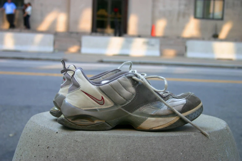 a shoe is resting on top of a cement block