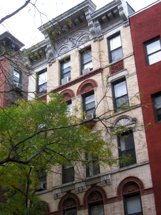 several buildings along the street are lined with trees