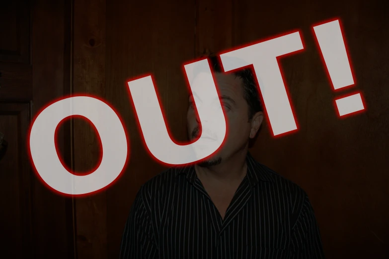 a man stands in front of a door that has a lighted out sign in it