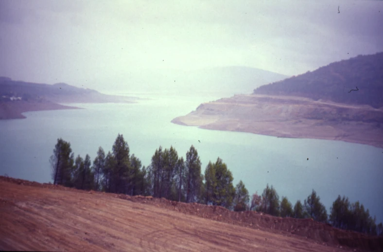 an aerial view of a mountain top area with trees