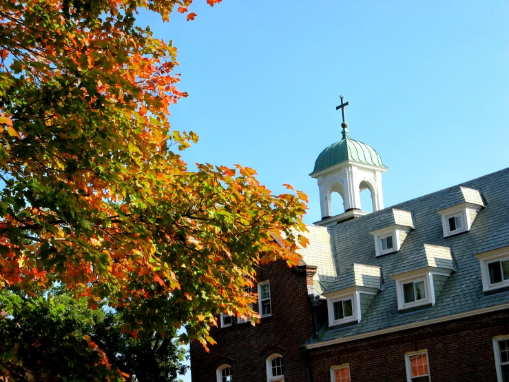 the building has two steeples and a weather vein