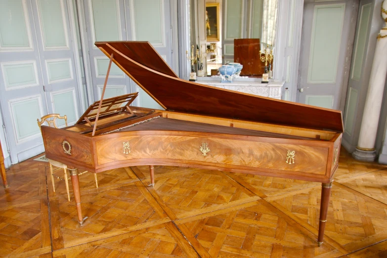 a piano sitting on top of a hard wood floor