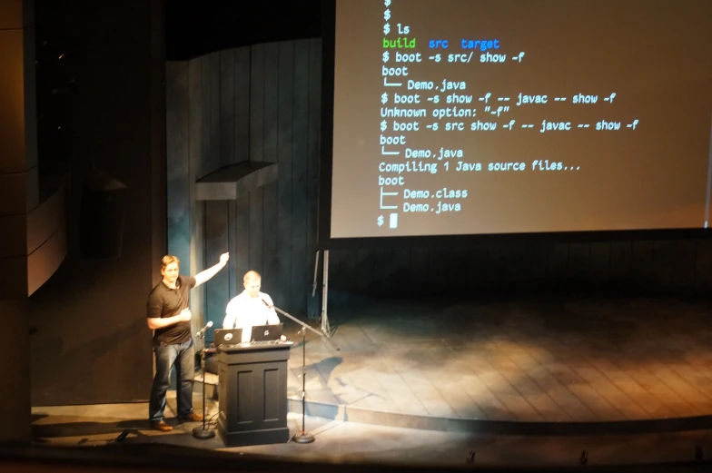 a woman standing at a podium giving a presentation