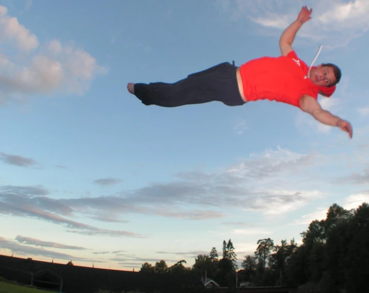 a man jumping into the air while catching a frisbee