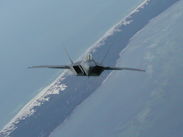 a fighter jet flies close to the camera