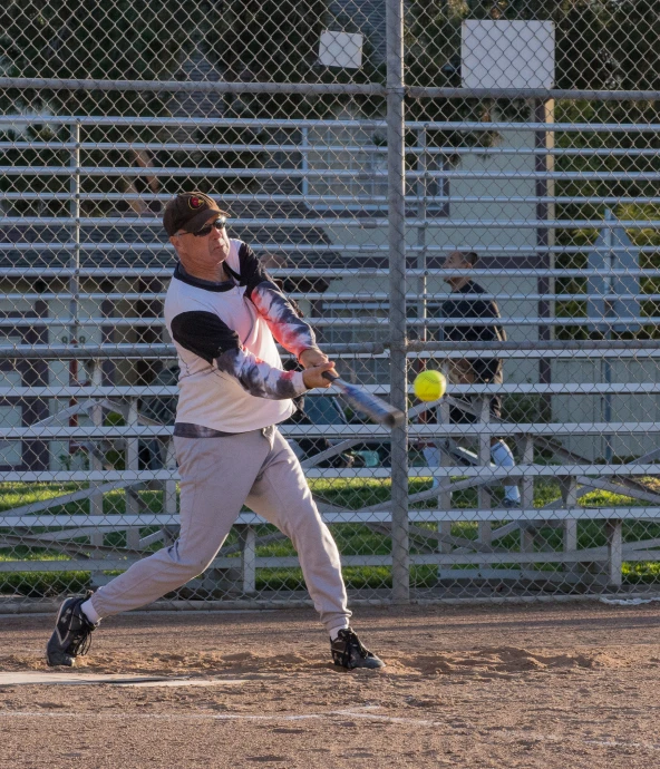 man taking a swing at the ball in front of a crowd